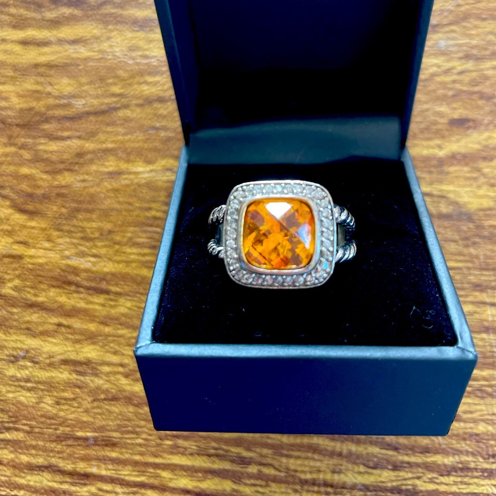 Designer inspired amber stone surrounded by crystals set in silver colored metal